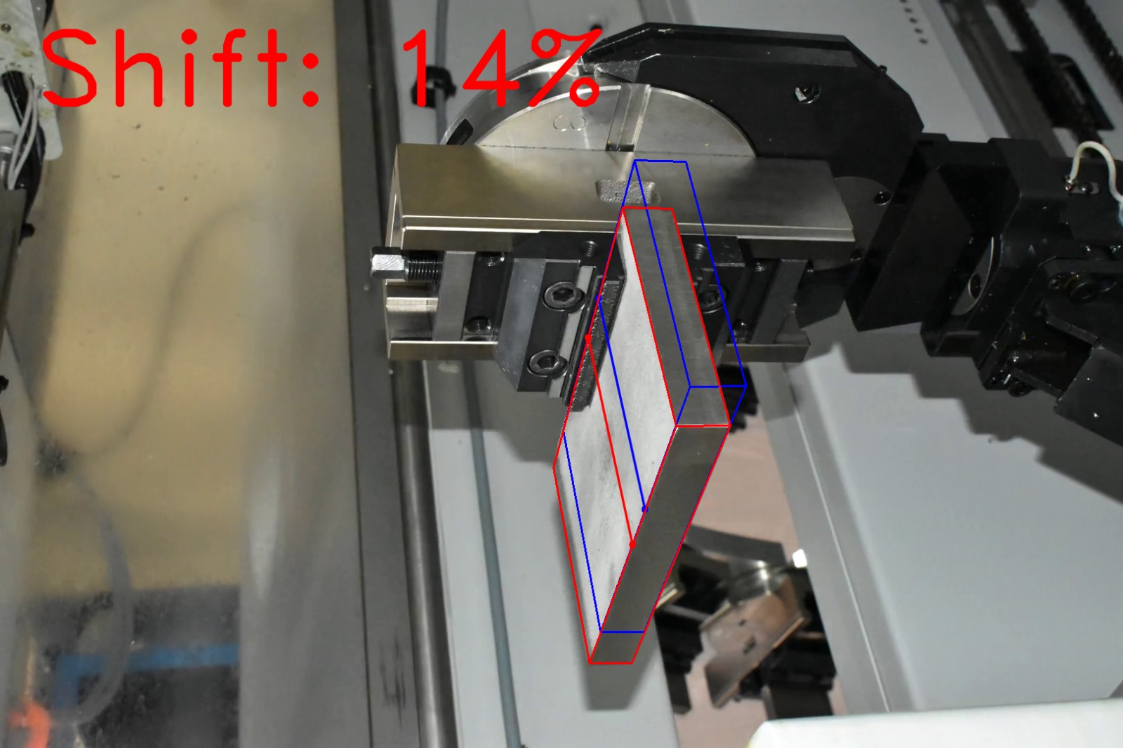 Computer vision shift estimation on factory photograph 4 of a metal block held by a CNC gripper