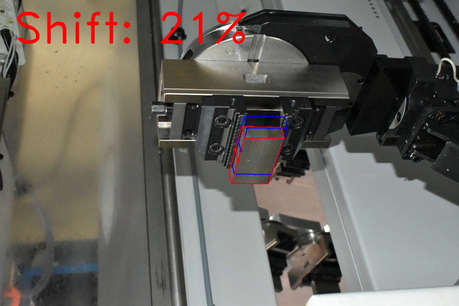 Computer vision shift estimation on factory photograph 6 of a metal block held by a CNC gripper