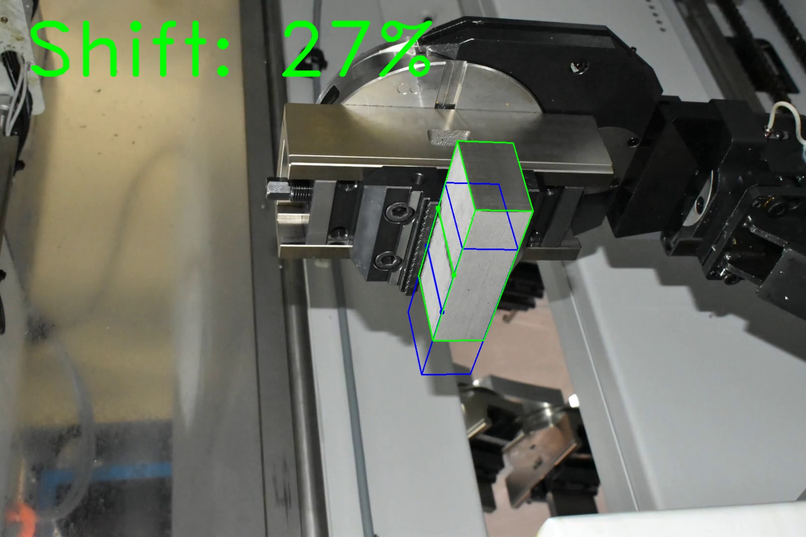 Computer vision shift estimation on factory photograph 8 of a metal block held by a CNC gripper