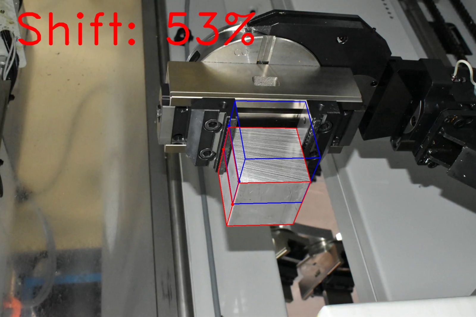 Computer vision shift estimation on factory photograph 9 of a metal block held by a CNC gripper