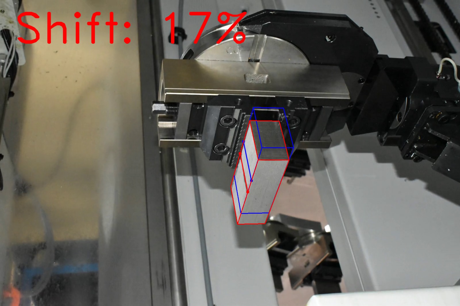 Computer vision shift estimation on factory photograph 10 of a metal block held by a CNC gripper