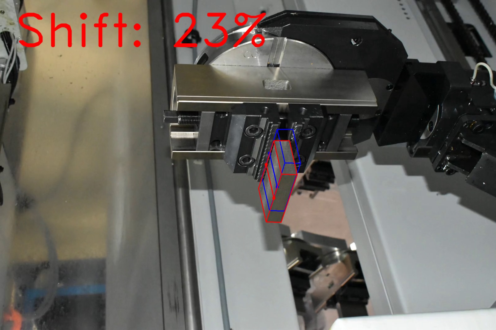 Computer vision shift estimation on factory photograph 11 of a metal block held by a CNC gripper